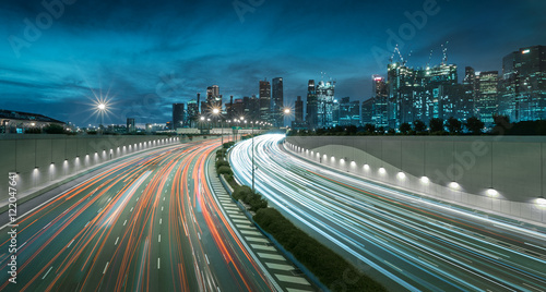 Movement of car light with Singapore cityscape skyline during twilight in dramatic tone