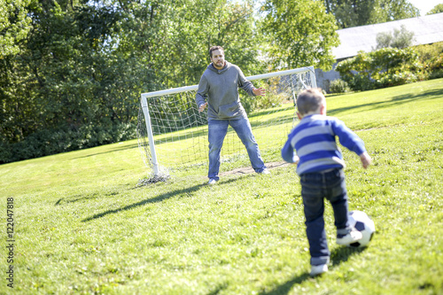 Father and Son Playing Ball in The Park