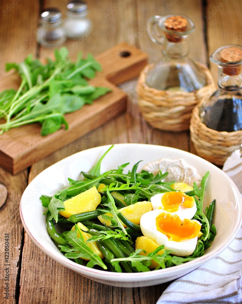 Vegetable salad with green beans, potatoes, arugula, eggs and olive oil. Vintage style. Vegetable salad with green beans, potatoes, arugula, eggs and olive oil. Vintage style.