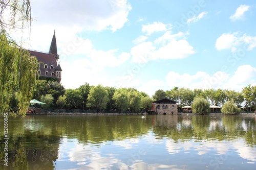 Medieval castle with high towers reflected in the water of the lake
