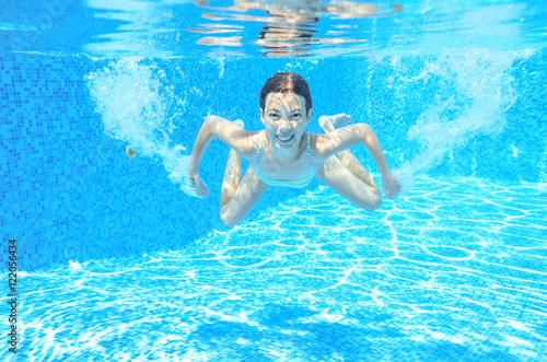 Child swims in pool underwater, happy active girl has fun under water, kid sport on family vacation   © Iuliia Sokolovska