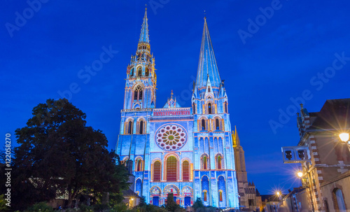 The illuminated Our Lady of Chartres cathedral, France. photo