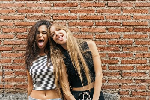 Two young crazy girls having fun photo