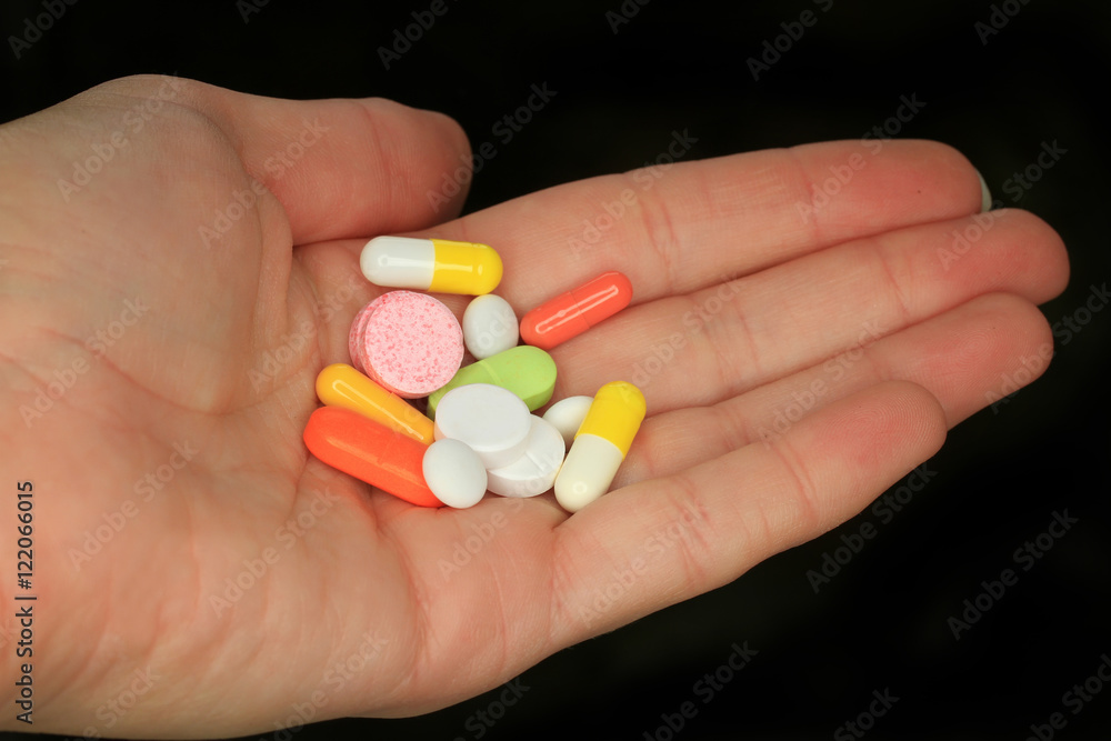 variety of pills and capsules lie in the palm of your hand variety of pills and capsules lie in the palm of your hand