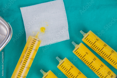 fat in syringes for fat grafting on sterile green fabric