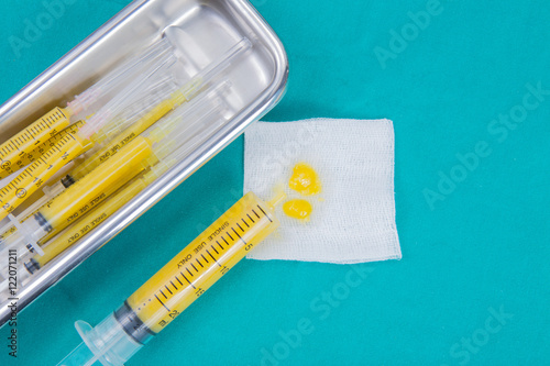 fat in syringes for fat grafting on sterile green fabric