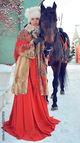 beautiful girl with a horse in the Siberian winter season