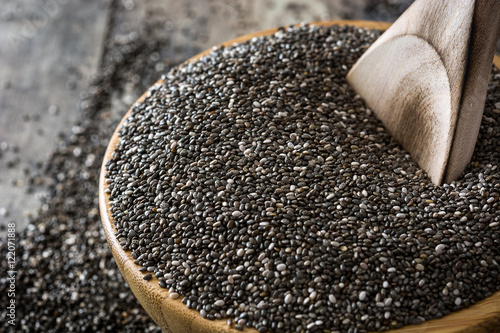 Chia seeds in a bowl on wooden table

