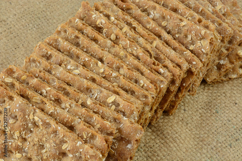 Multi grain whole grain crispbread crackers on burlap photo