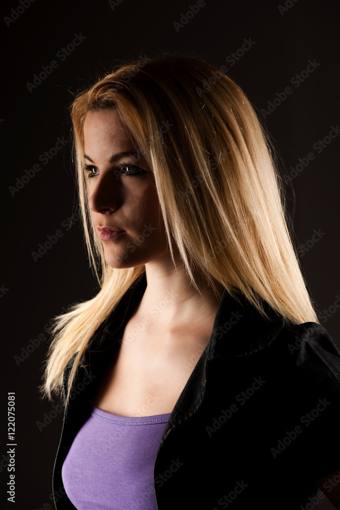 Portrait of a beautiful blonde woman over dark gray background Portrait of a beautiful blonde woman over dark gray background