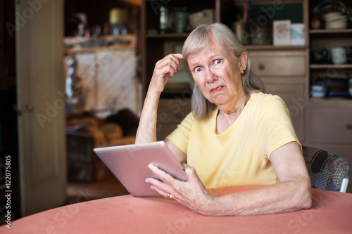Woman confused with tablet computer