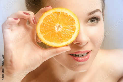 Young beautiful girl with slice of orange