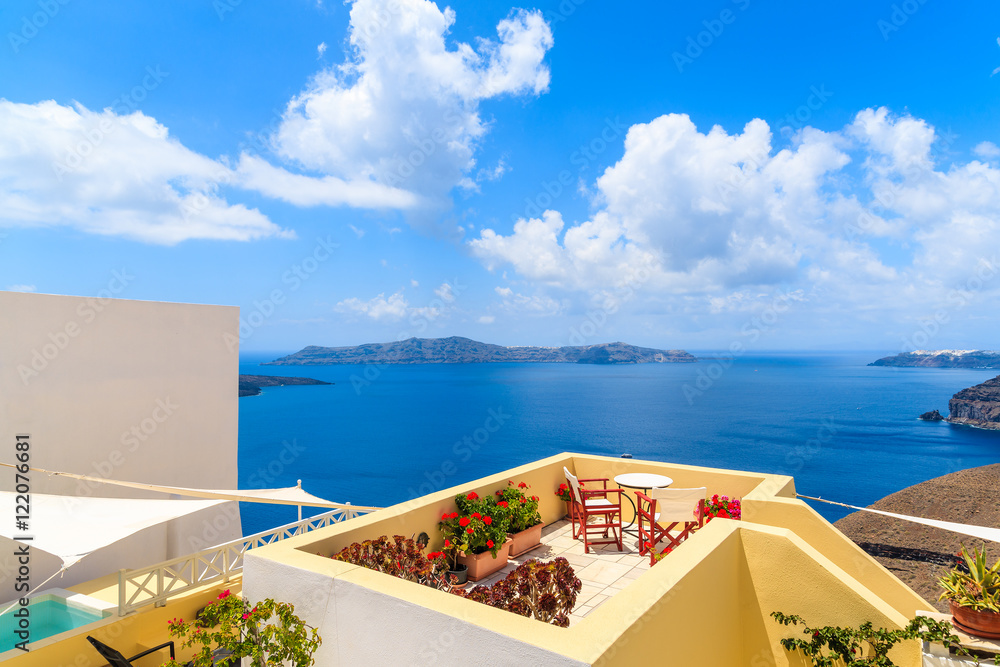 Fototapeta premium Chairs and table on terrace with sea view in beautiful Firostefa