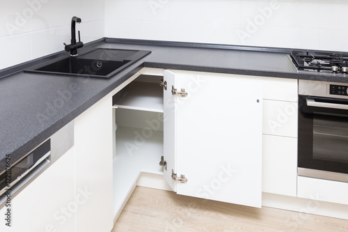 Solution for a kitchen corner in a cupboard. The angular opening with corner hinges.