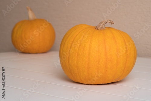 Yellow pumpkin on white garden table