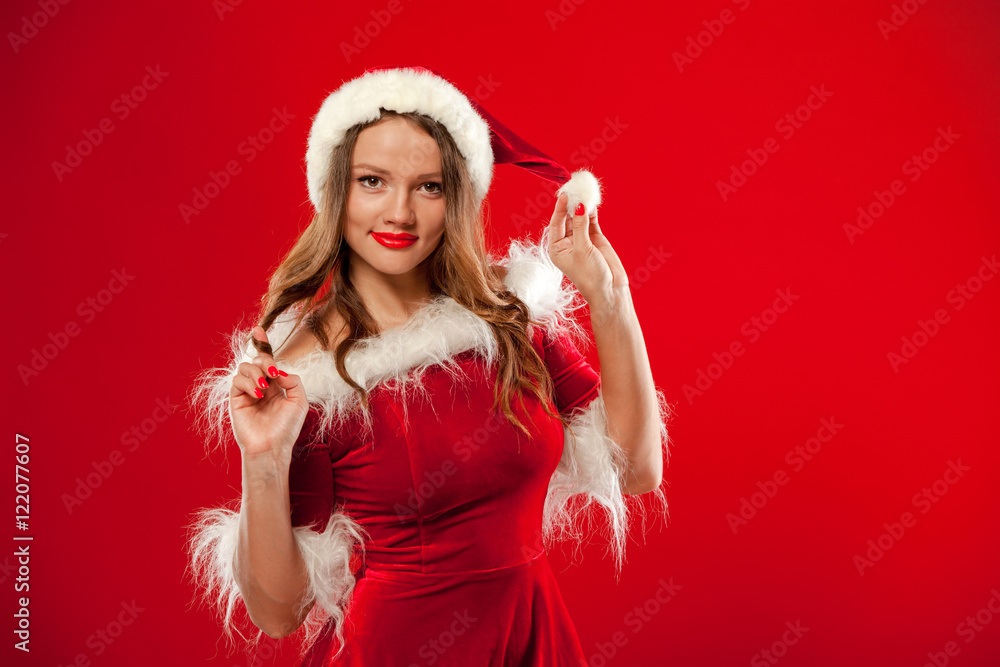 christmas Close up portrait of beautiful sexy girl wearing santa claus clothes, over red background christmas Close up portrait of beautiful sexy girl wearing santa claus clothes, over red background