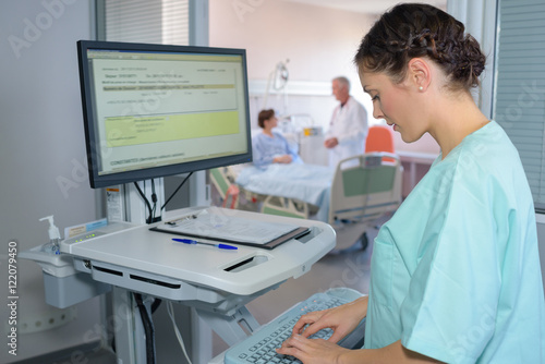 Tableau sur toile Nurse typing on computer keyboard