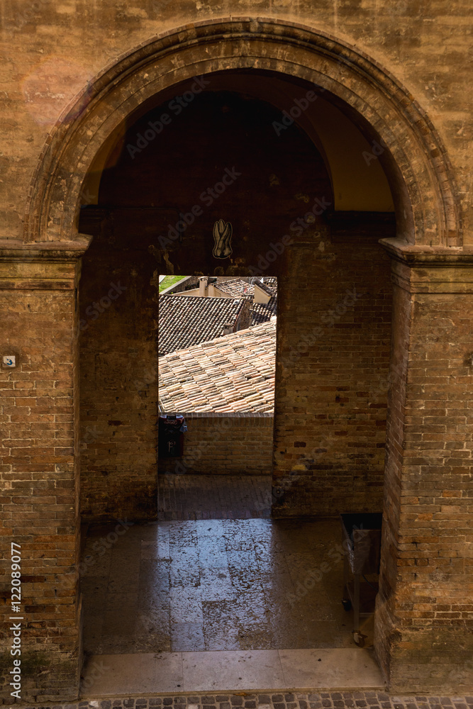 Fototapeta premium View over roof from a window framed by columns in Urbino