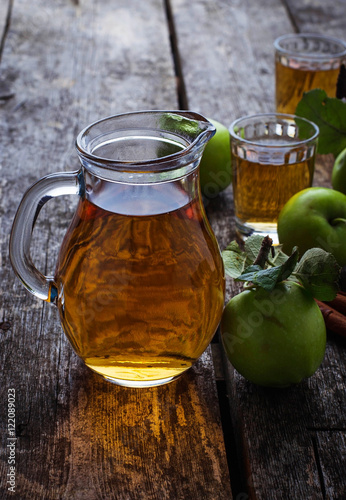 Glasses with apple juice on wooden table