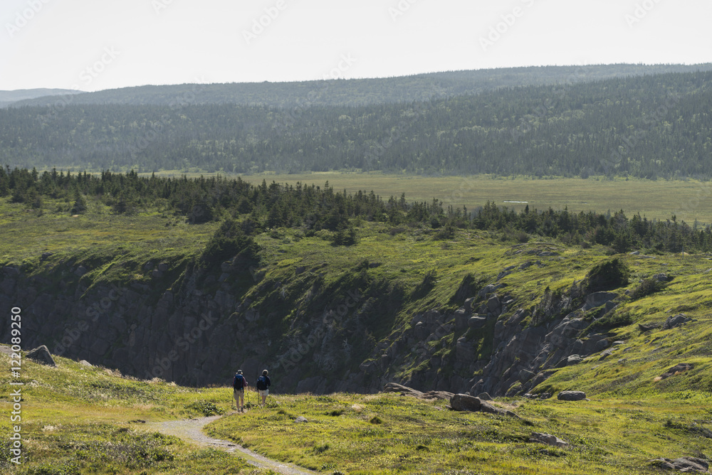 Two people hiking on Avalon Peninsula, Newfoundland, Canada