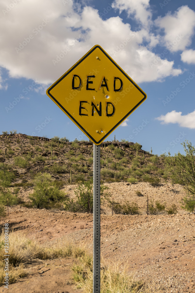 DEAD END Road Sign with Bullet Holes and Peeling Letters in Arizona Desert