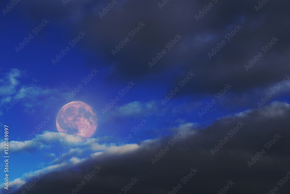 Background for design of the full moon of black clouds and light.