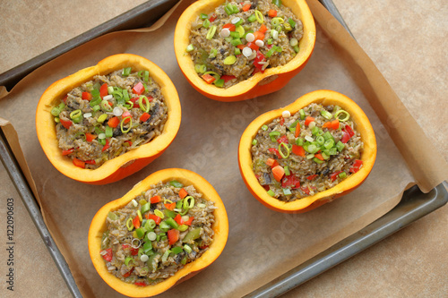 Autumn stuffed pumpkin with rice and mushrooms ready to bake