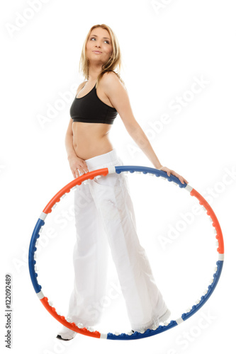sporty fit girl doing exercise with hula hoop.