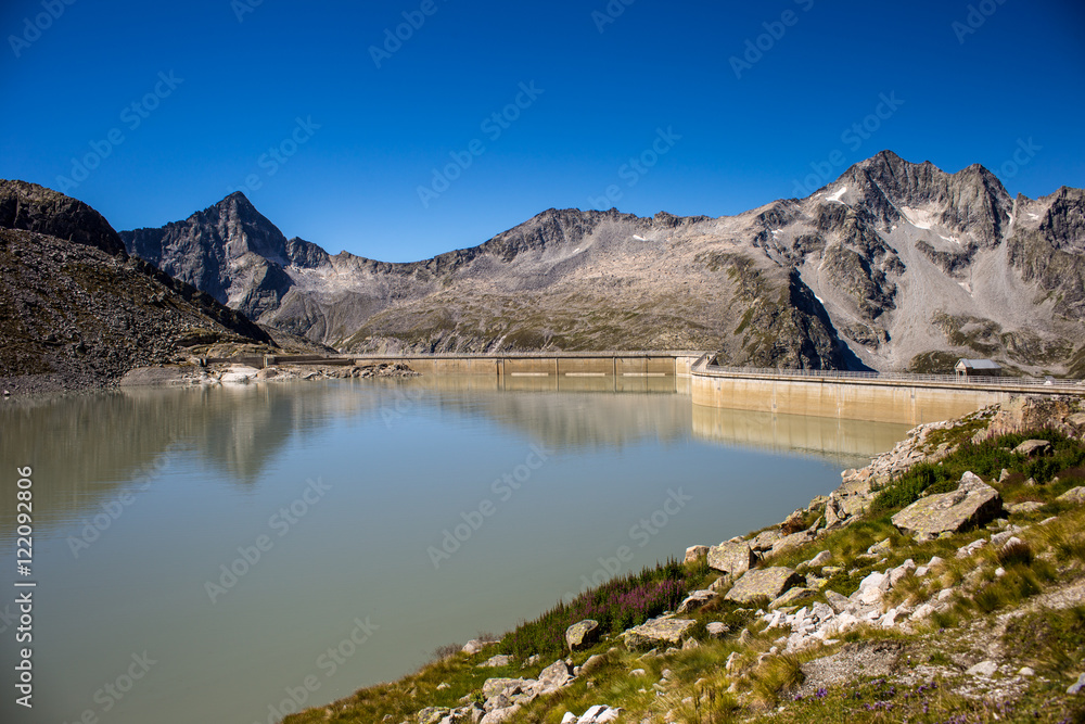 Venerocolo lake and its dam at the foot of Adamello mountain