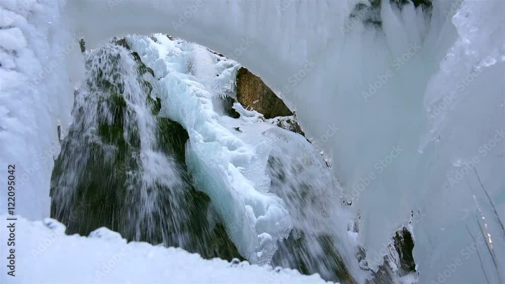 Wonderful waterfall in winter time with traces of ice melting in pure mountain environment, ULTRA HD 4k,real time Wonderful waterfall in winter time with traces of ice melting in pure mountain environment, ULTRA HD 4k,real time