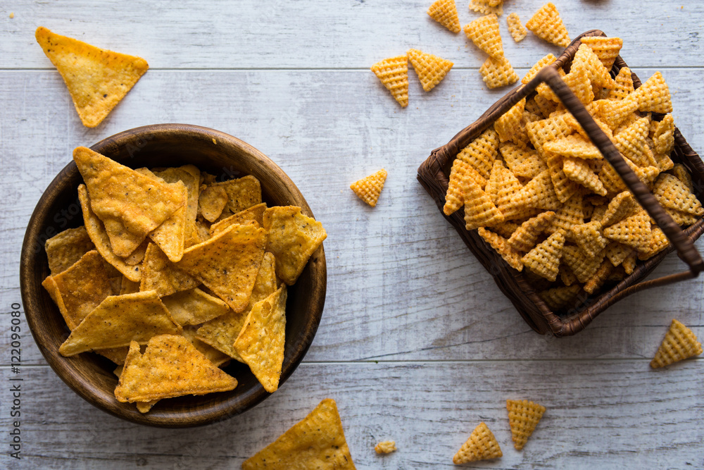 Chips (Snacks) on a white wooden surface. Chips (Snacks) on a white wooden surface.