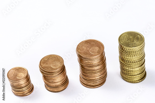 Different eurocent coins stacked in columns, on white. Blank space at top