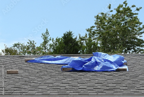 Blue Tarp Covering Residential Roof Leak