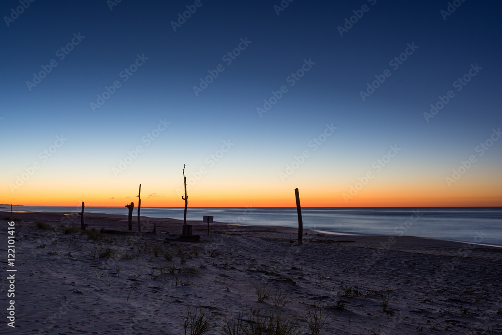 The sun rises across the Atlantic Ocean from east Long Island, New York