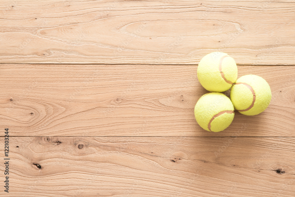 Tennis on brown wood