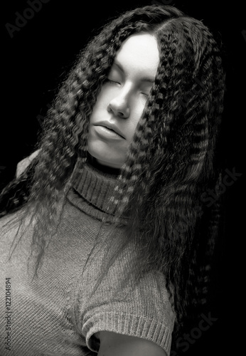 Portrait of pretty young woman with curly hair 