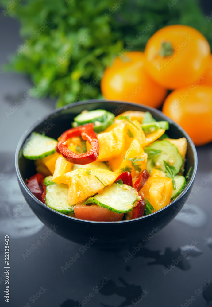 Close Up of colorful salad from tomatoes, cucumbers, peppers and
