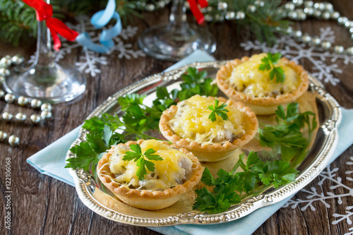 Holiday appetizer: tartlets with mushrooms and meat on a celebra