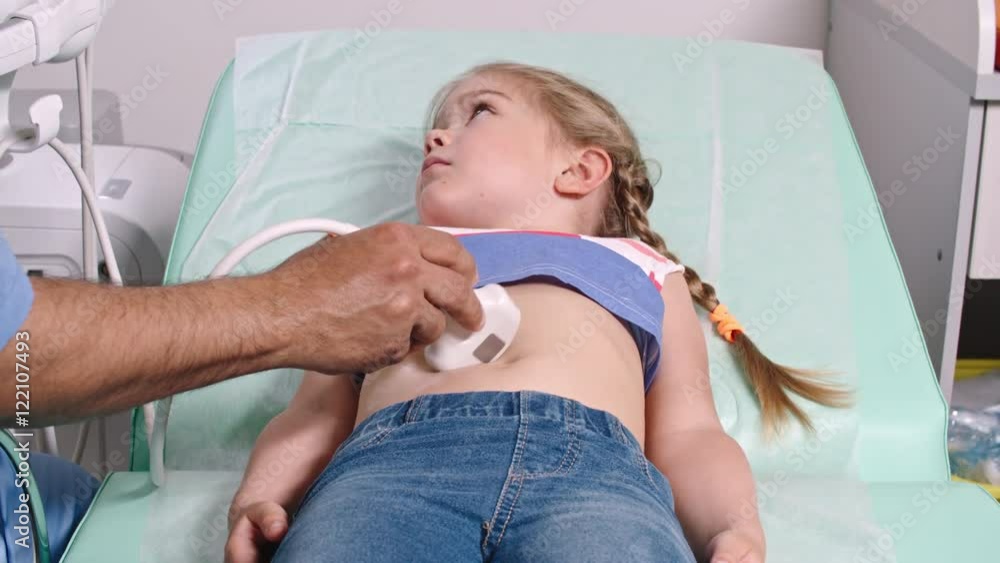 Little girl lying on examination bed at doctor appointment and ...