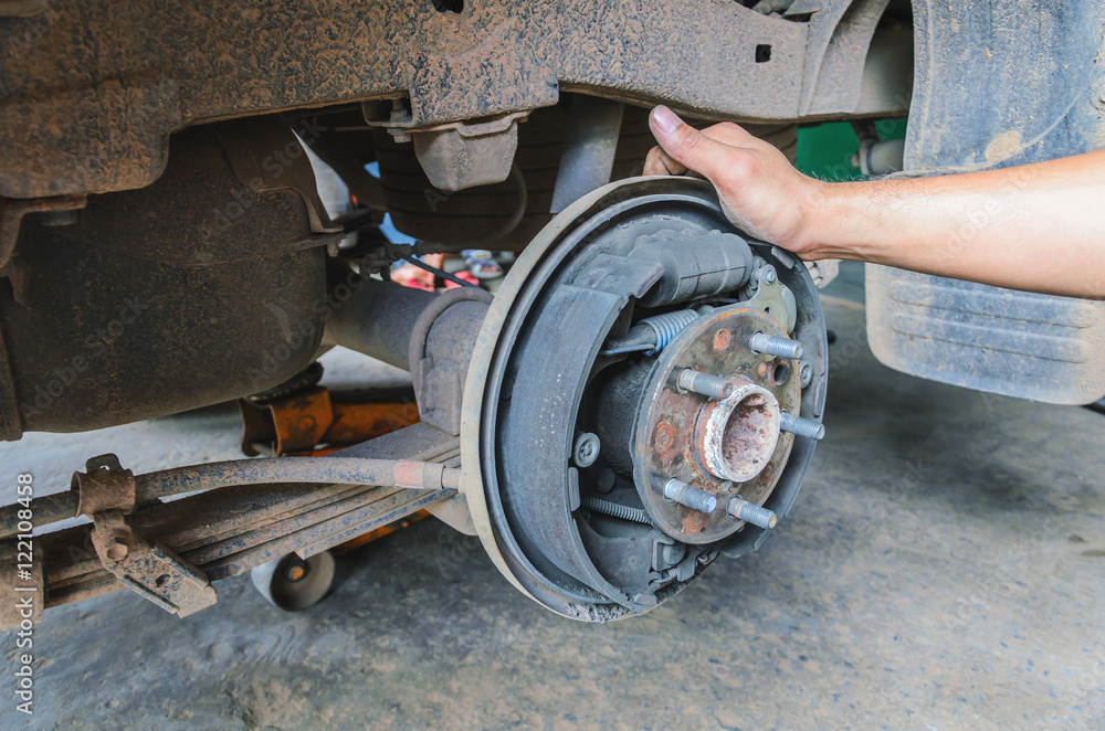 Fototapeta premium mechanic changing maintenance Disc brake on car