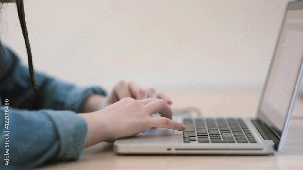 Female hands working on laptop in the room Female hands working on laptop in the room