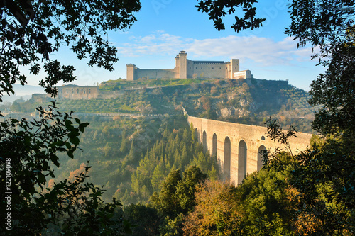 Spoleto (Italy) - A misty fall day in the charming medieval village in Umbria region. The soft focus depends on dense fog, which, however, creates an evocative atmosphere with Sun rays  photo