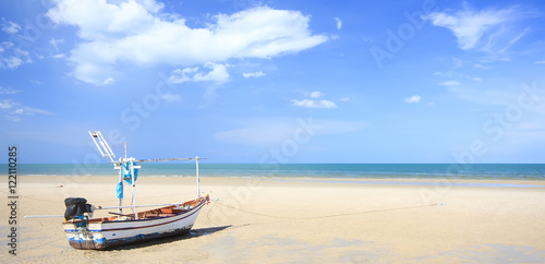 Tourist and fishing boat on the beach in Thailand