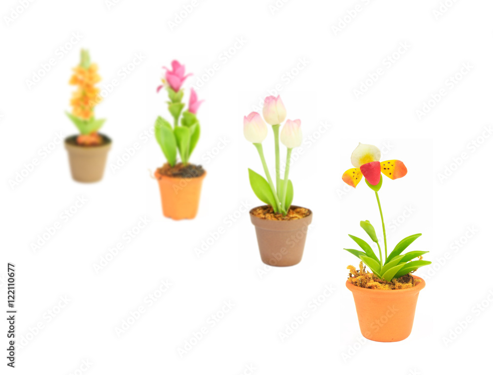 gradient focus fake flower sets in flowerpot on white background
