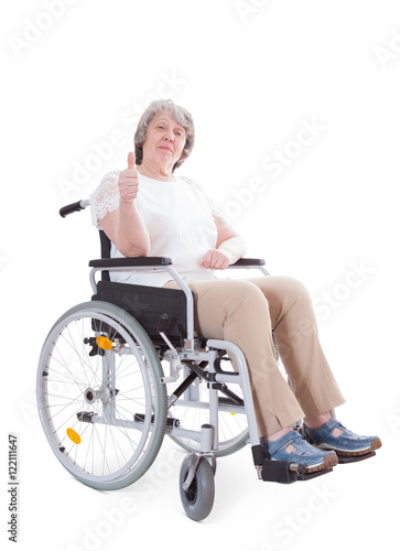 Senior sitting in wheelchair showing thumbs up