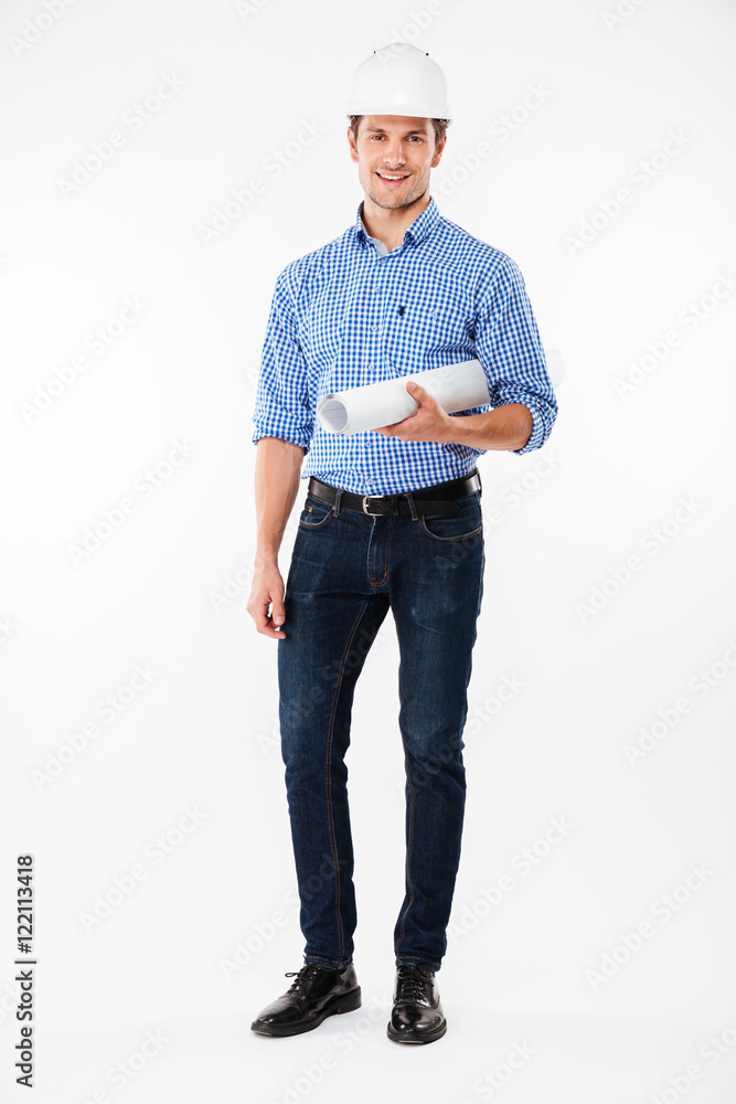 Cheerful man builder in hard hat standing and holding blueprint Cheerful man builder in hard hat standing and holding blueprint