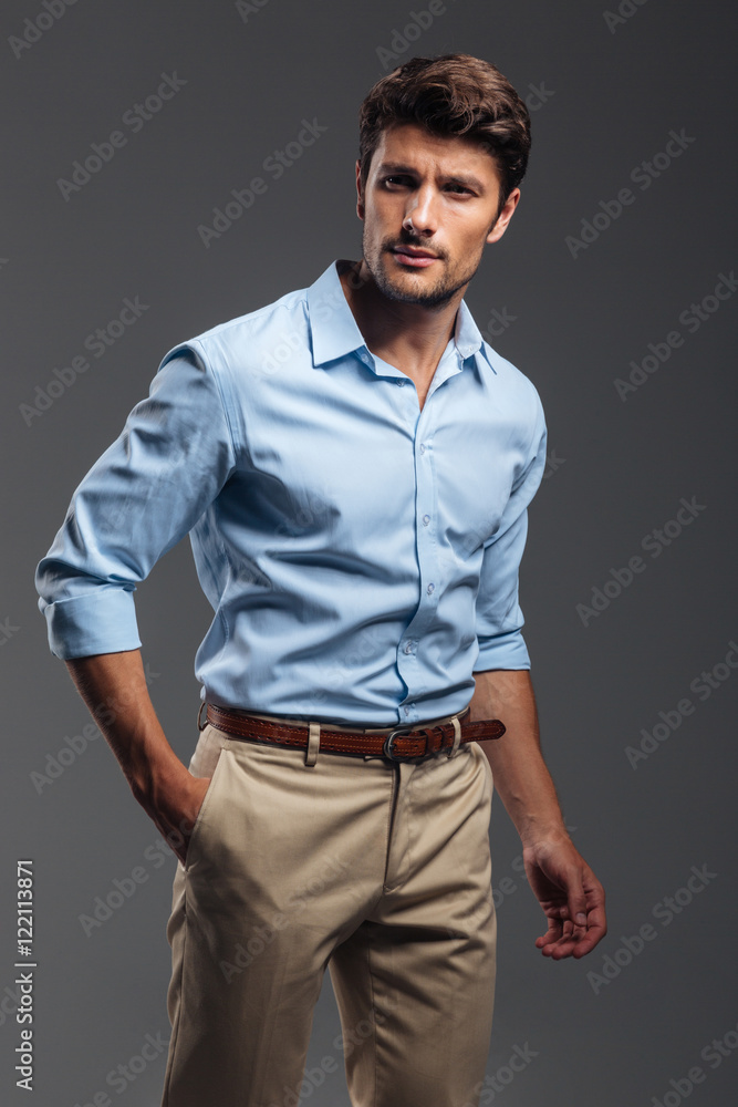 Handsome young man standing with hand in pocket Handsome young man standing with hand in pocket