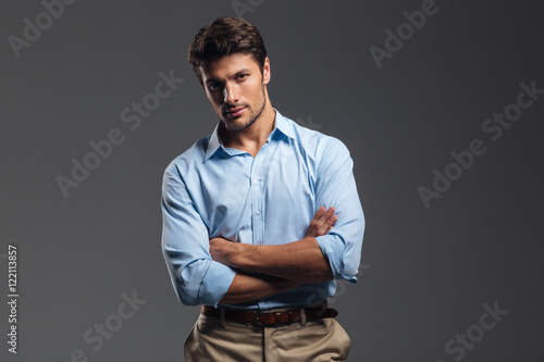 Successful handsome man with arms folded standing