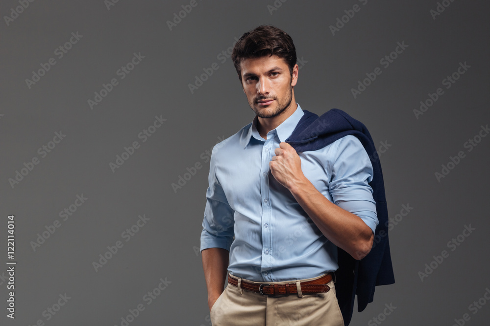 Handsome businessman holding his jacket over shoulder Handsome businessman holding his jacket over shoulder