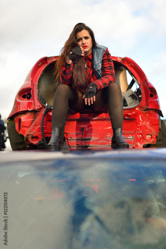 brunette girl posing in a car scrappage